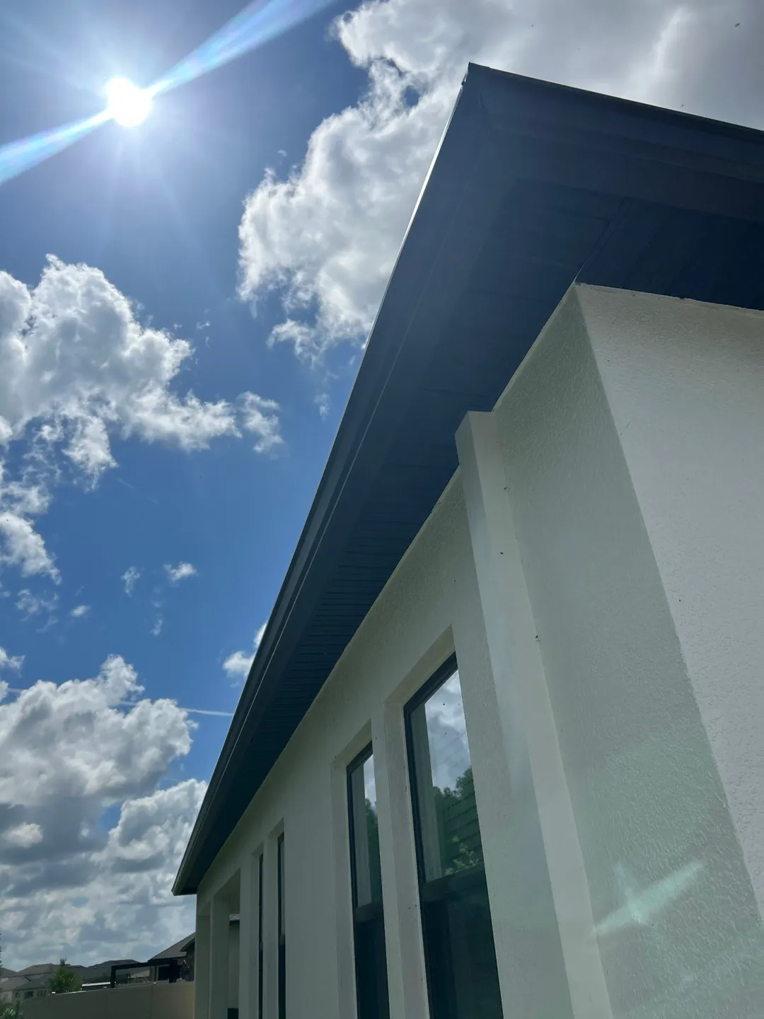 Musket Brown seamless gutter running along the roofline of a Brandon FL home, seen from below