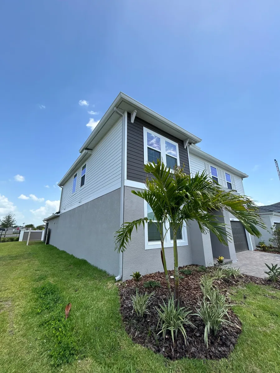 30 Degree White seamless gutters and 3x4 downspout on a two-story New Port Richey FL home