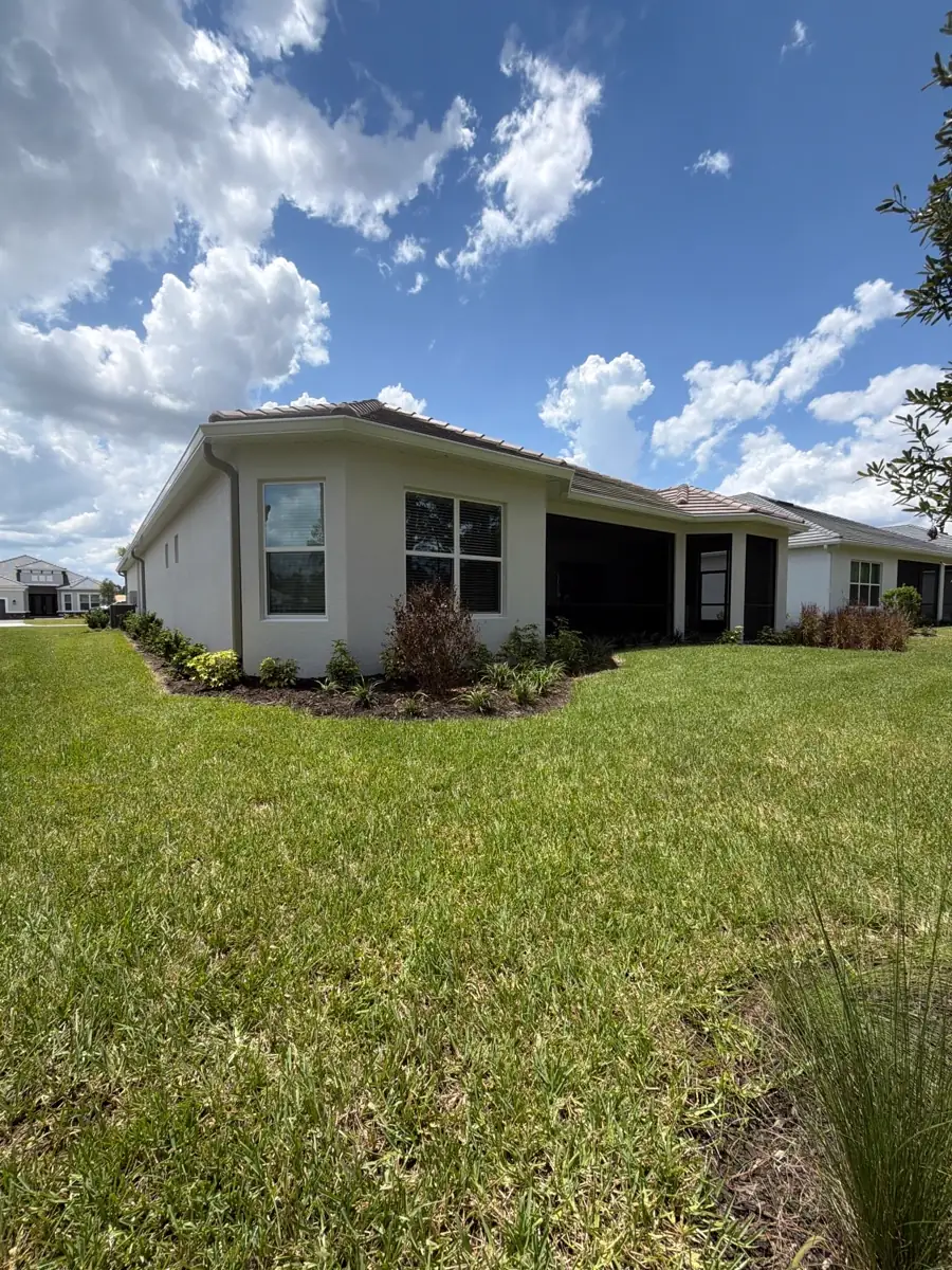 Completed seamless gutter and downspout installation on a Wesley Chapel tile-roof home
