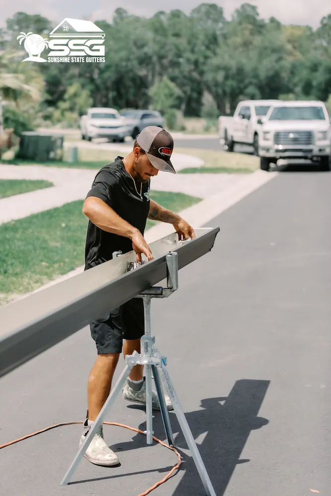 Sunshine State Gutters installer attaching a seamless gutter to the fascia
