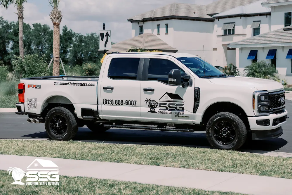 Sunshine State Gutters work truck parked in front of a Florida home during a gutter installation